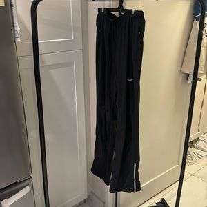 Nike track pants with zippered pockets and zipped cuffs